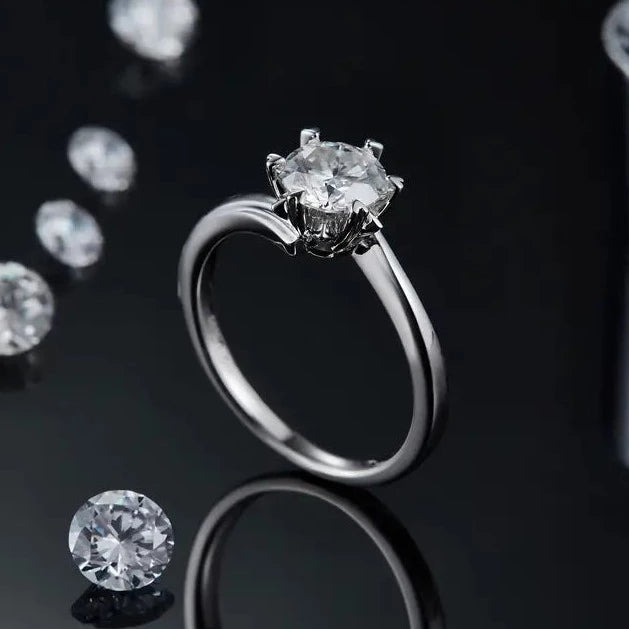 A beautiful engagement ring featuring a 1.00ct Moissanite, set into a sterling silver ring with a 6 claw setting, to create a snowflake effect.