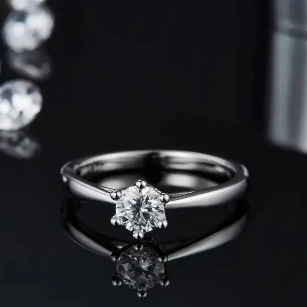 A classic 6 claw solitaire engagement ring displaying a 0.50ct moissanite with a special floral designed basket, all made of sterling silver.