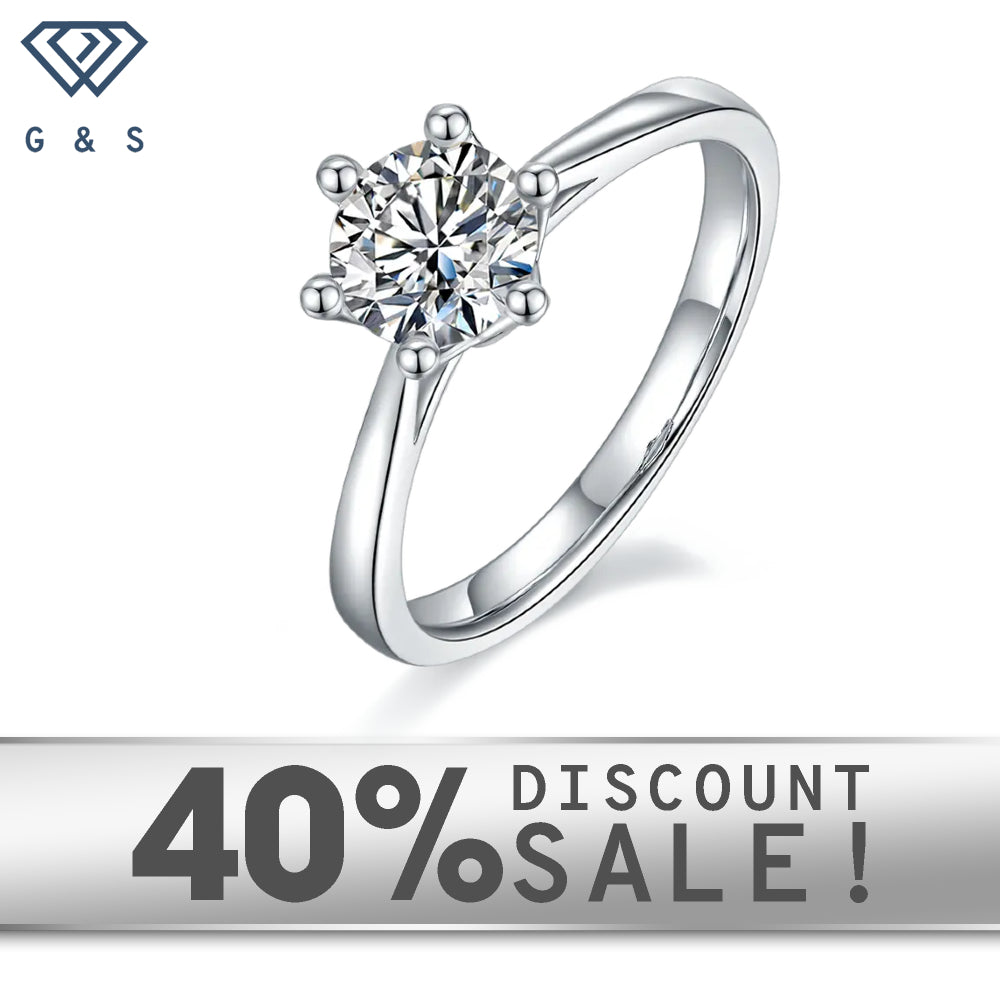 A 1.00ct moissanite sparkles in a timeless 6-claw setting with a delicate floral basket design, crafted in 9ct white gold.