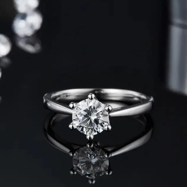 This elegant ring features a 1.00ct moissanite held securely in a 6-claw setting with a captivating floral basket design.