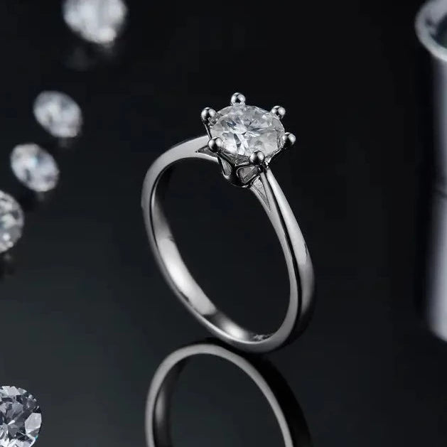 Experience timeless elegance with this 1.00ct moissanite engagement ring, featuring a 6-claw setting and a delicate floral basket design in 9ct white gold.