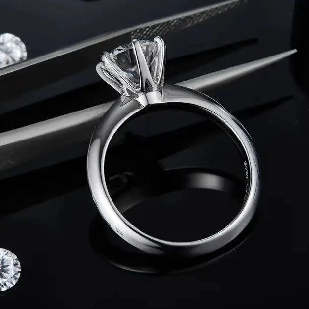 A sterling silver engagement ring highlighting a 1.50ct moissanite in a classic Tiffany inspired 6-prong setting for maximum brilliance.