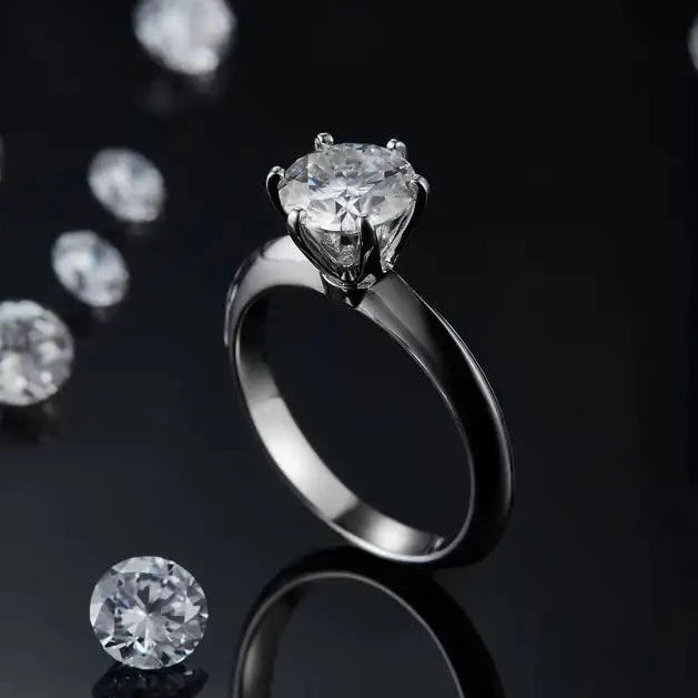 This stunning ring features a brilliant 1.50ct moissanite in a classic 6-claw setting, crafted from high-quality sterling silver.
