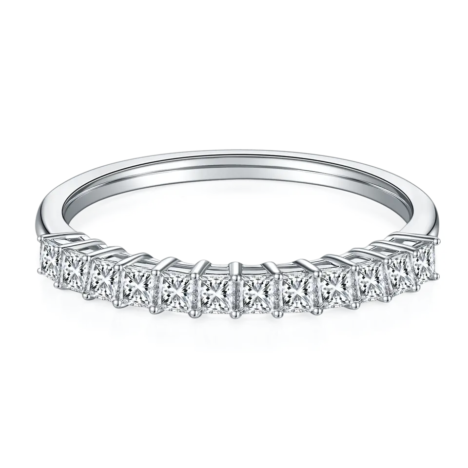 This wedding band set showcases sparkling square brilliant moissanites set halfway around a polished sterling silver band.