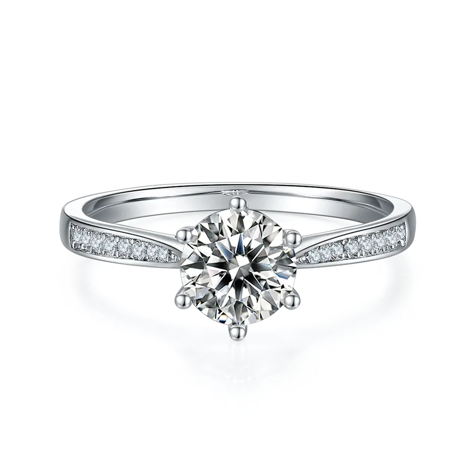 This elegant ring showcases a brilliant 1.00ct moissanite center stone with a delicate, tapered pave setting on a sterling silver band.