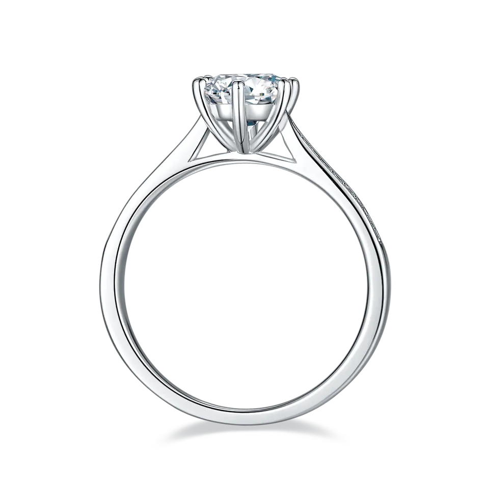 A stunning engagement ring featuring a 1.00ct moissanite center stone, set in sterling silver with a tapered band adorned with shimmering pave moissanites.