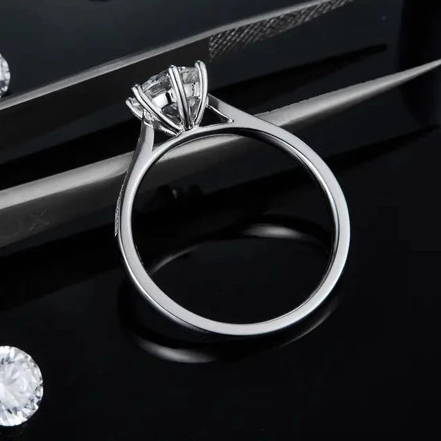 This ring features a 1.00ct moissanite center stone, set in a sterling silver band with a refined, tapered pave design for added sparkle.