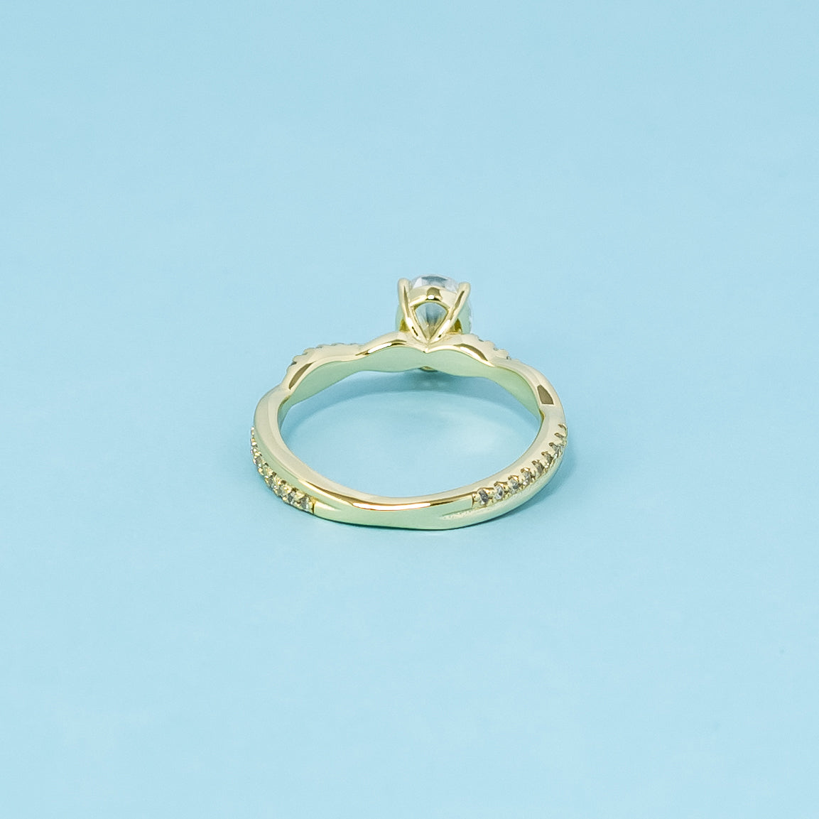 A symbol of everlasting love, this 9ct yellow gold ring features an oval cut moissanite and an elegant infinity design.