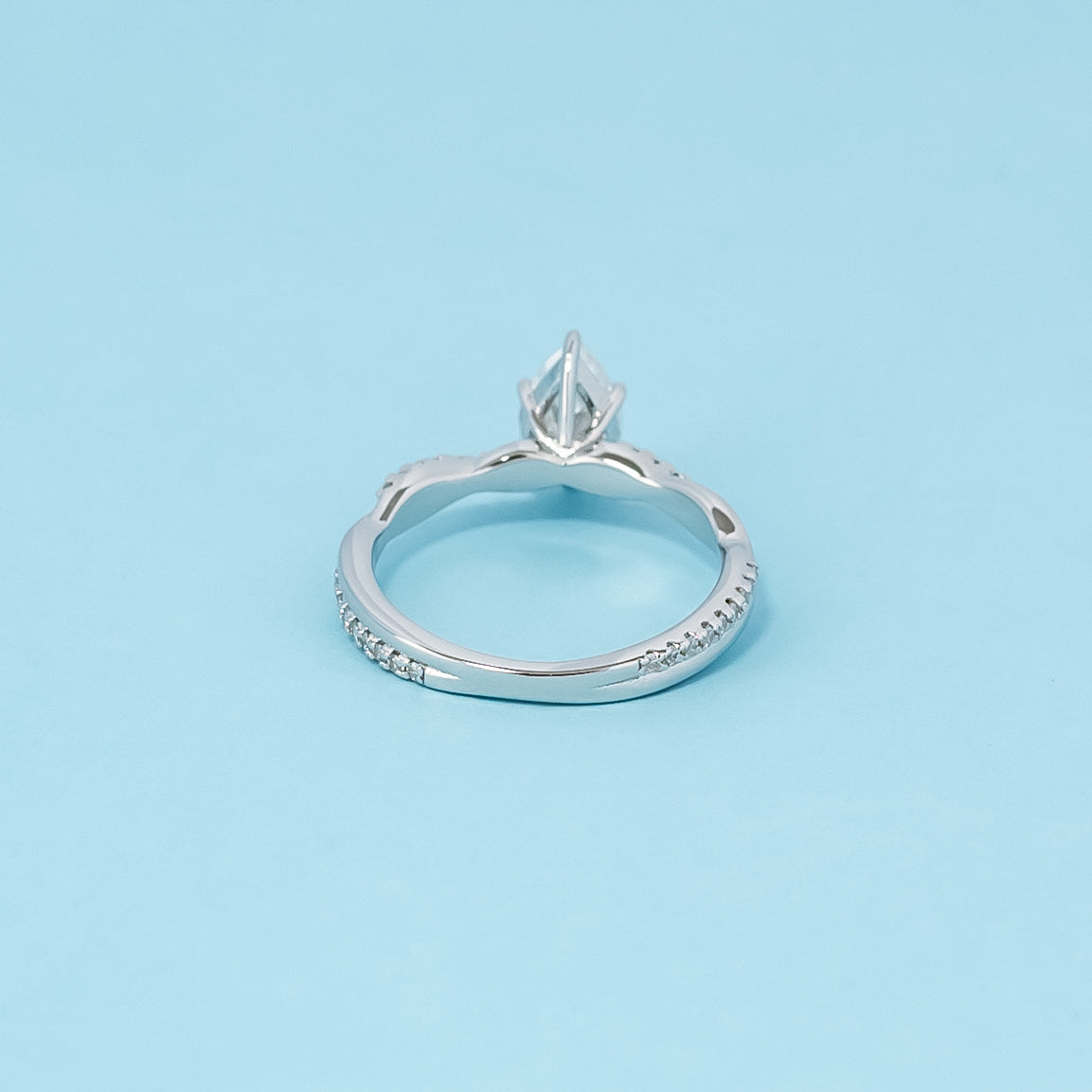 Elegant 9ct White Gold Engagement Ring showcasing a sparkling Pear Shape Moissanite set within an Infinity design.