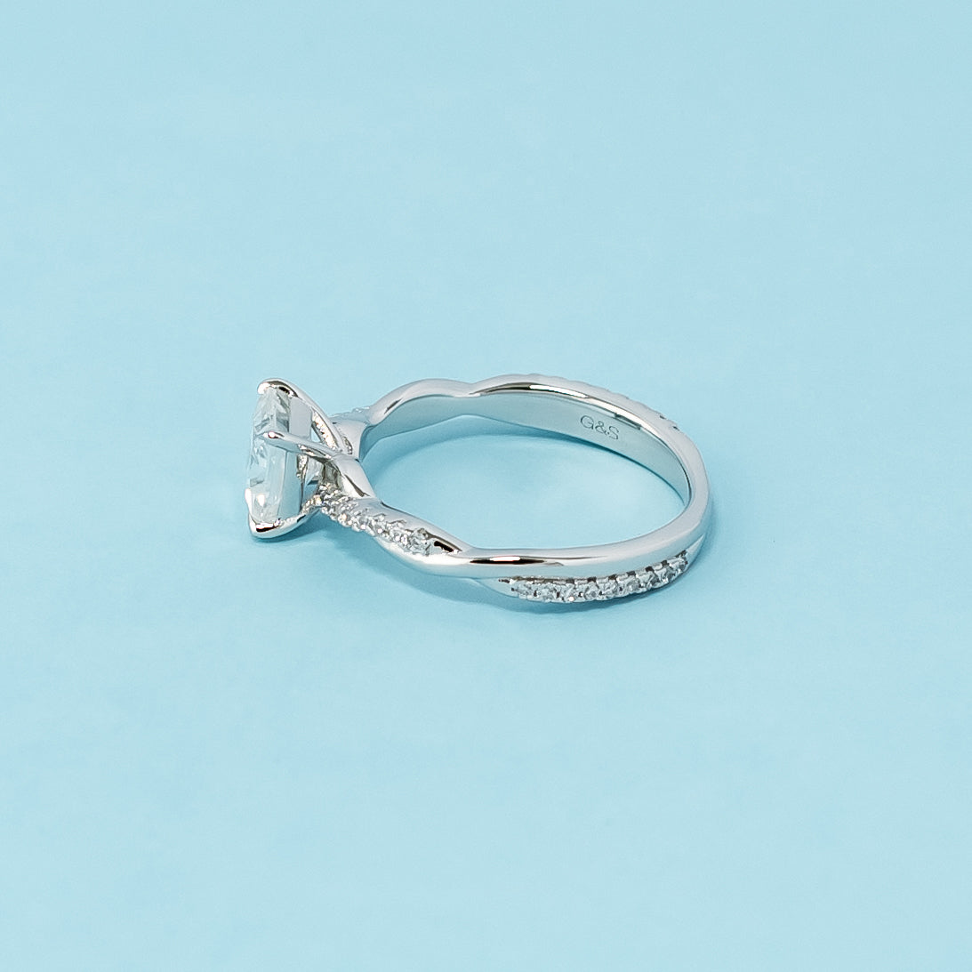 Classic and sophisticated engagement ring showcasing a princess cut moissanite in a symbolic infinity setting, crafted in 9ct white gold.