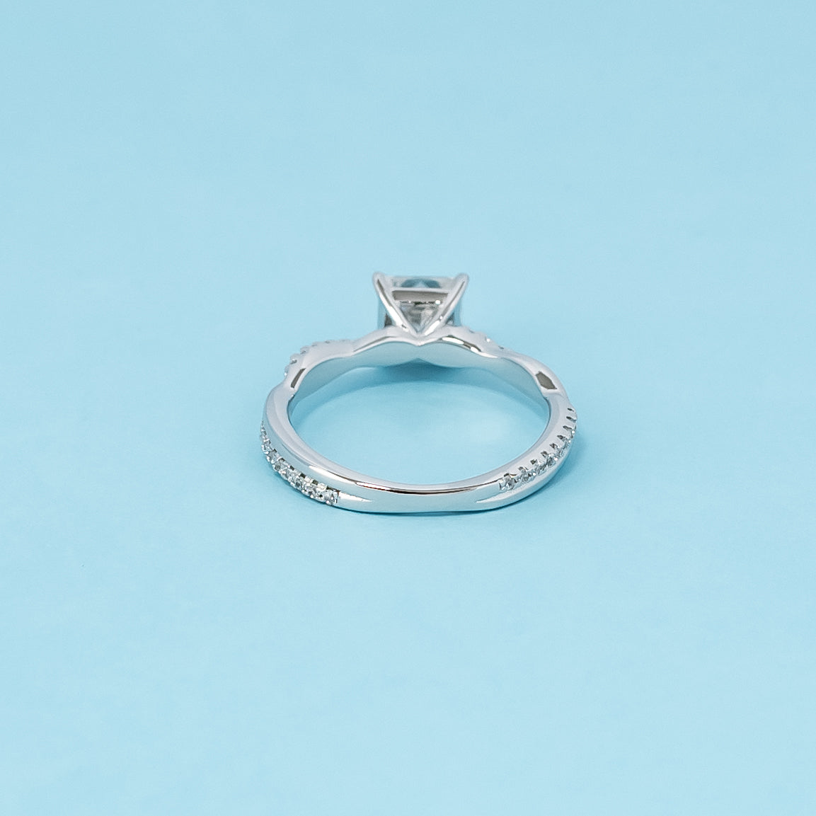 Luxurious 9ct white gold engagement ring with a beautiful princess cut moissanite in a timeless infinity design, representing everlasting love.