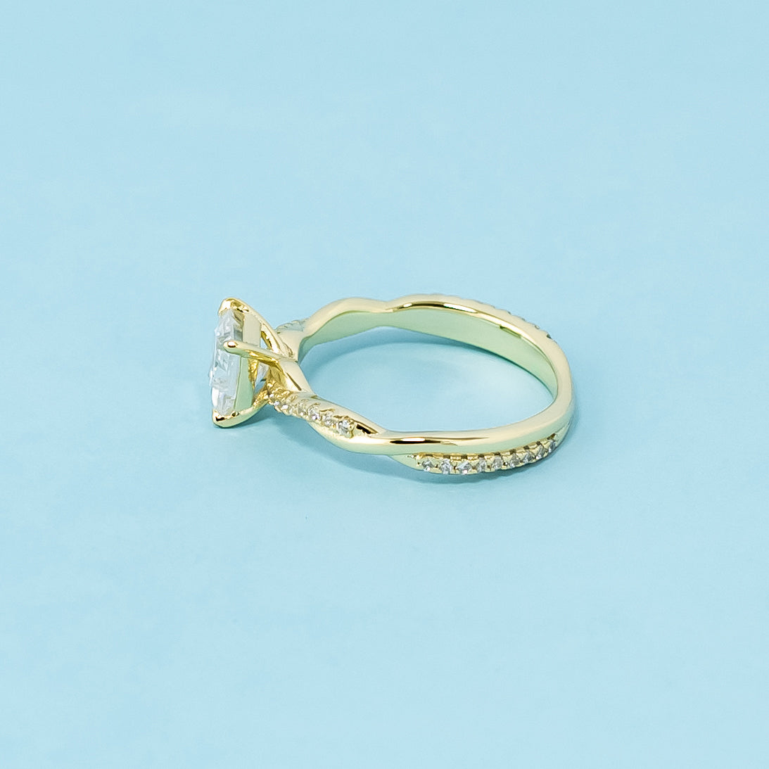 This 9ct yellow gold ring features a classic princess cut moissanite with a delicate infinity design element.