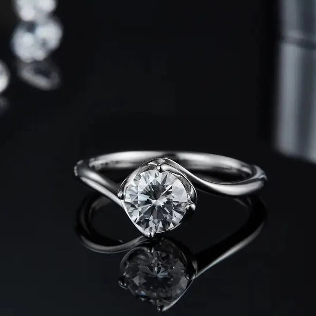 This ring features a sparkling 1.00ct moissanite solitaire elevated by a beautifully designed twist basket, all crafted in high-quality sterling silver.