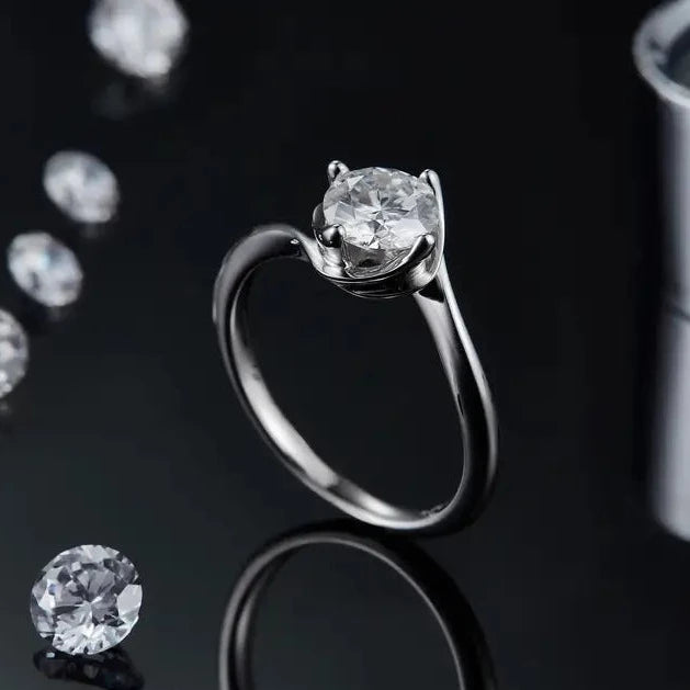 A sterling silver engagement ring showcasing a brilliant 1.00ct moissanite in a contemporary twist basket setting, offering a fresh take on a traditional design.