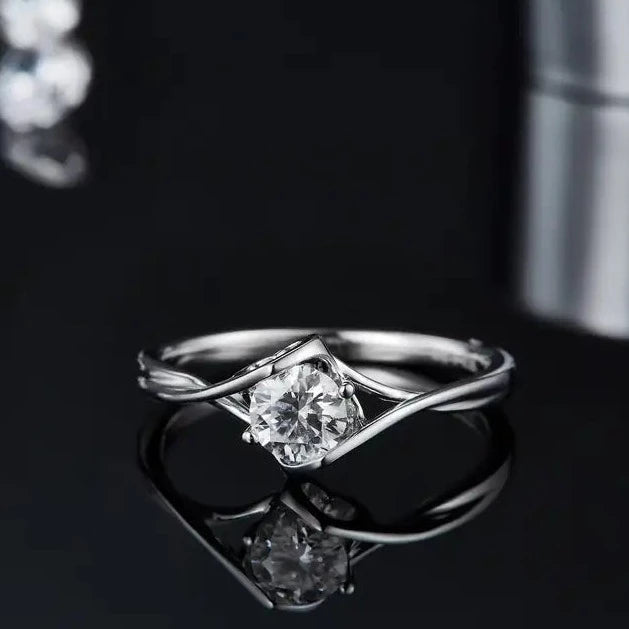 This distinctive engagement ring features a 0.50ct moissanite set within a captivating two-heart design, crafted from elegant sterling silver.