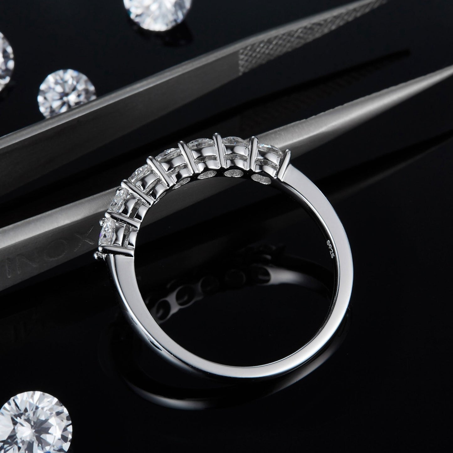 This sophisticated wedding band set features seven stones set in a half eternity design, offering a delicate and lasting beauty in sterling silver.