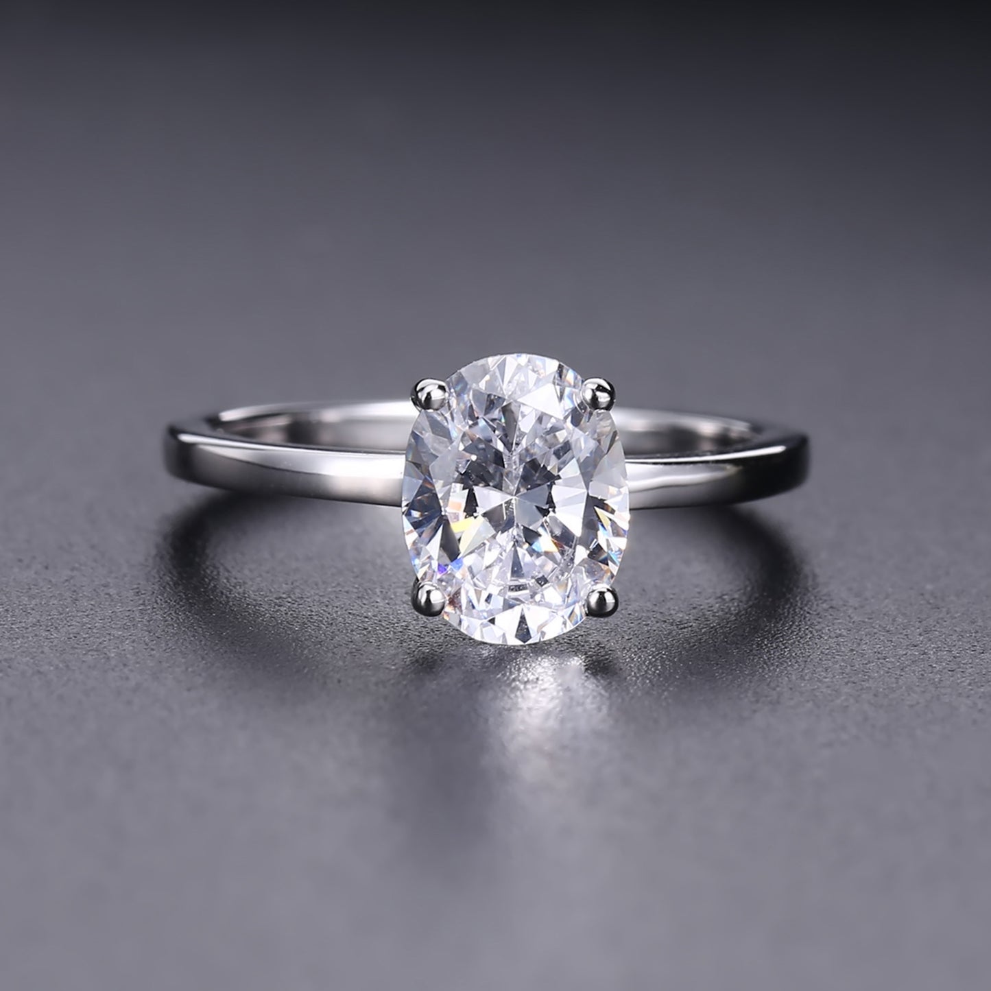 This sterling silver engagement ring showcases a stunning 1.00ct oval moissanite as the focal point, set in a traditional 4-prong design.