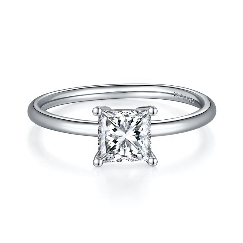 A simple and elegant engagement ring featuring a brilliant princess cut moissanite held securely by four prongs.