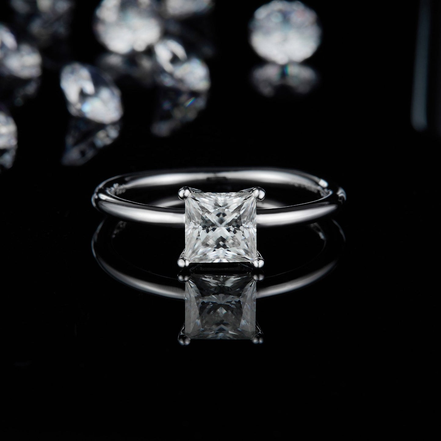 A timeless design featuring a 1.00ct princess cut moissanite secured by four prongs on a sleek sterling silver band.