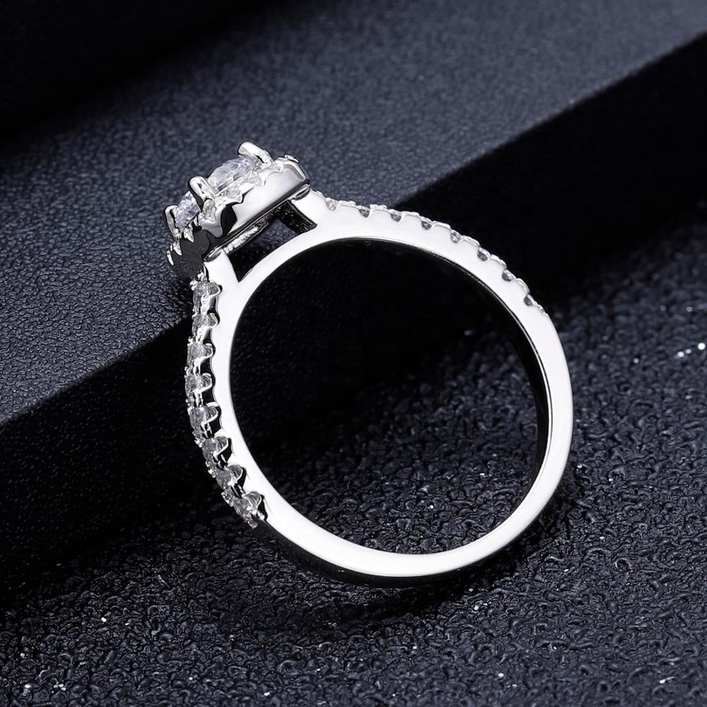 A timeless engagement ring featuring a 0.50ct moissanite with a classic halo, set in a polished sterling silver band.