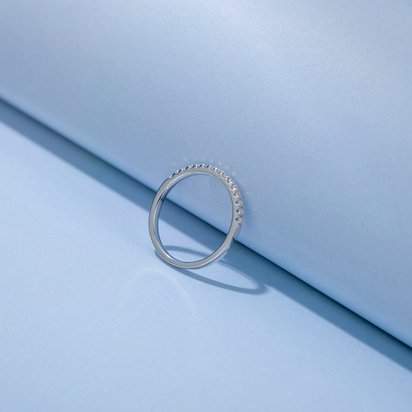 Matching wedding bands in polished sterling silver, each featuring a row of brilliant moissanites, perfect for couples seeking a timeless symbol of commitment.