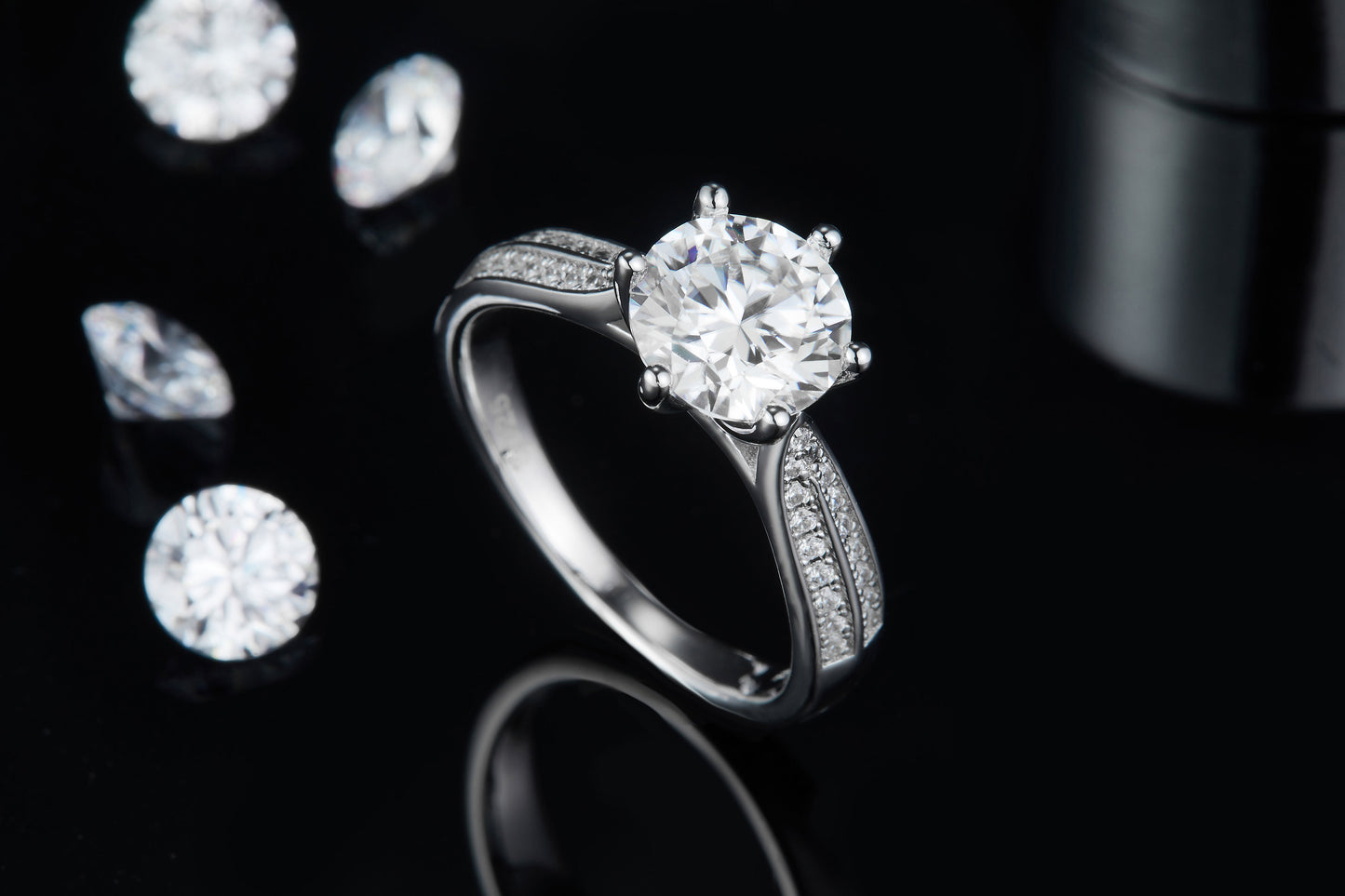 A 2.00ct moissanite is the centerpiece of this ring, surrounded by a pave halo and band for maximum sparkle, set in sterling silver.