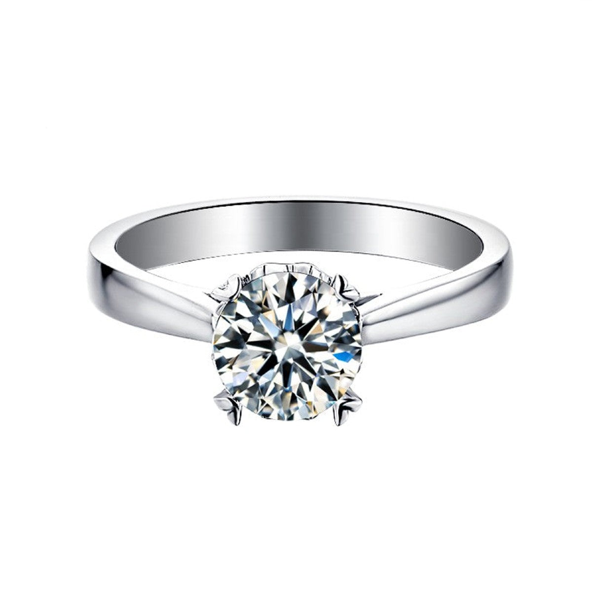 Showcasing a brilliant 1.00ct moissanite held securely in a classic 4-prong setting with heart-shaped claws.