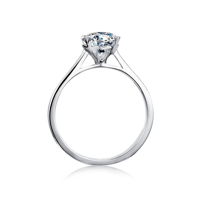 Featuring heart-shaped claws, this elegant 9ct white gold ring showcases a 1.00ct moissanite with exceptional brilliance.