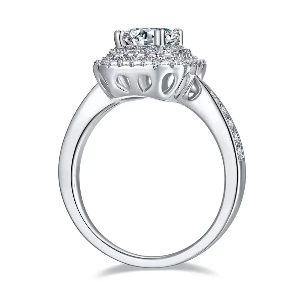 A dazzling engagement ring showcasing a 1.00ct emerald cut moissanite with a double halo setting.