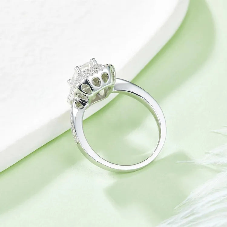 A luxurious engagement ring with a 1.00ct emerald cut moissanite and two layers of shimmering halo stones.