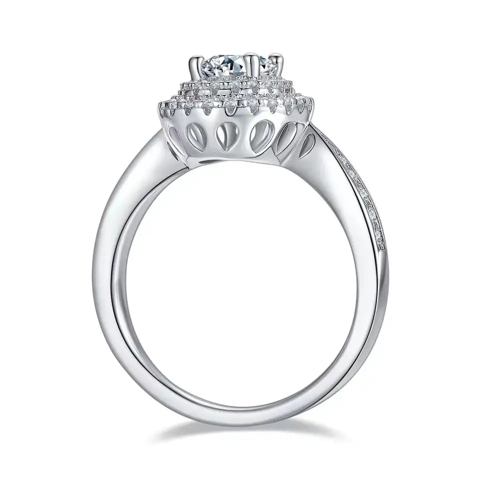 A luxurious engagement ring with a 1.00ct oval moissanite and two layers of shimmering halo stones.