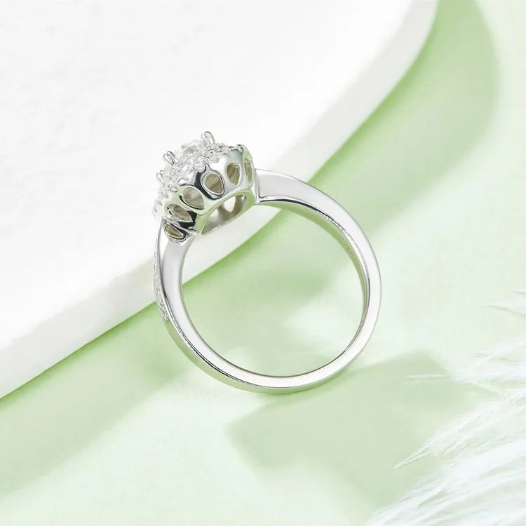 A dazzling engagement ring with a 1.00ct oval moissanite and a double halo, featuring a pave setting for extra brilliance.