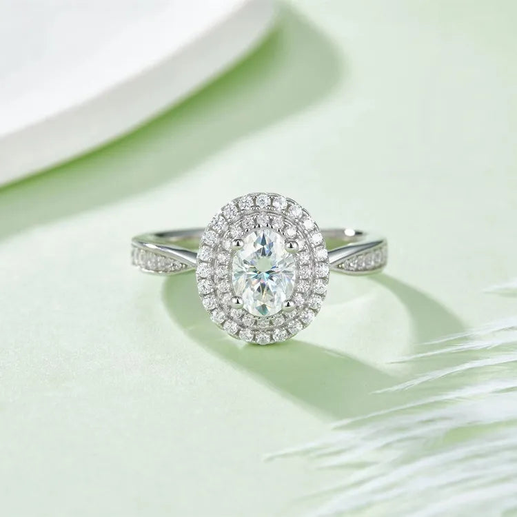 A captivating engagement ring with a 1.00ct oval moissanite and a double halo that creates a grand and luxurious look.