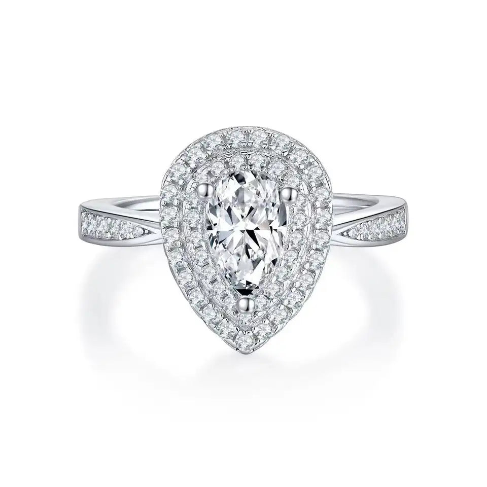 A close-up view of a pear-shaped moissanite engagement ring featuring a double halo setting for enhanced brilliance.