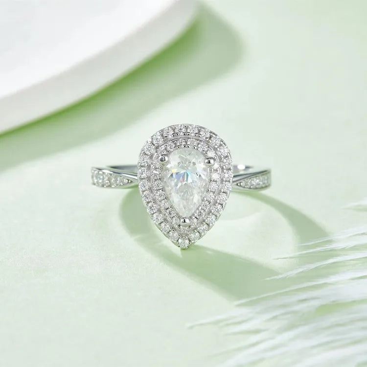 A focused image emphasizing the fine details of the double halo and the unique pear shape of the center stone.