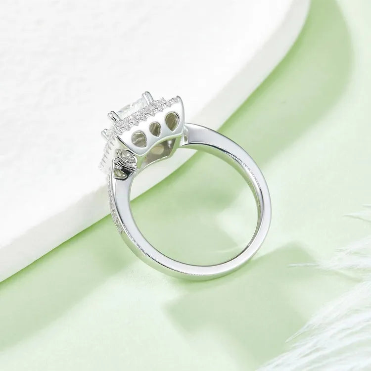A captivating ring with a 1.00ct princess cut moissanite centerpiece and a double halo design for extra brilliance.