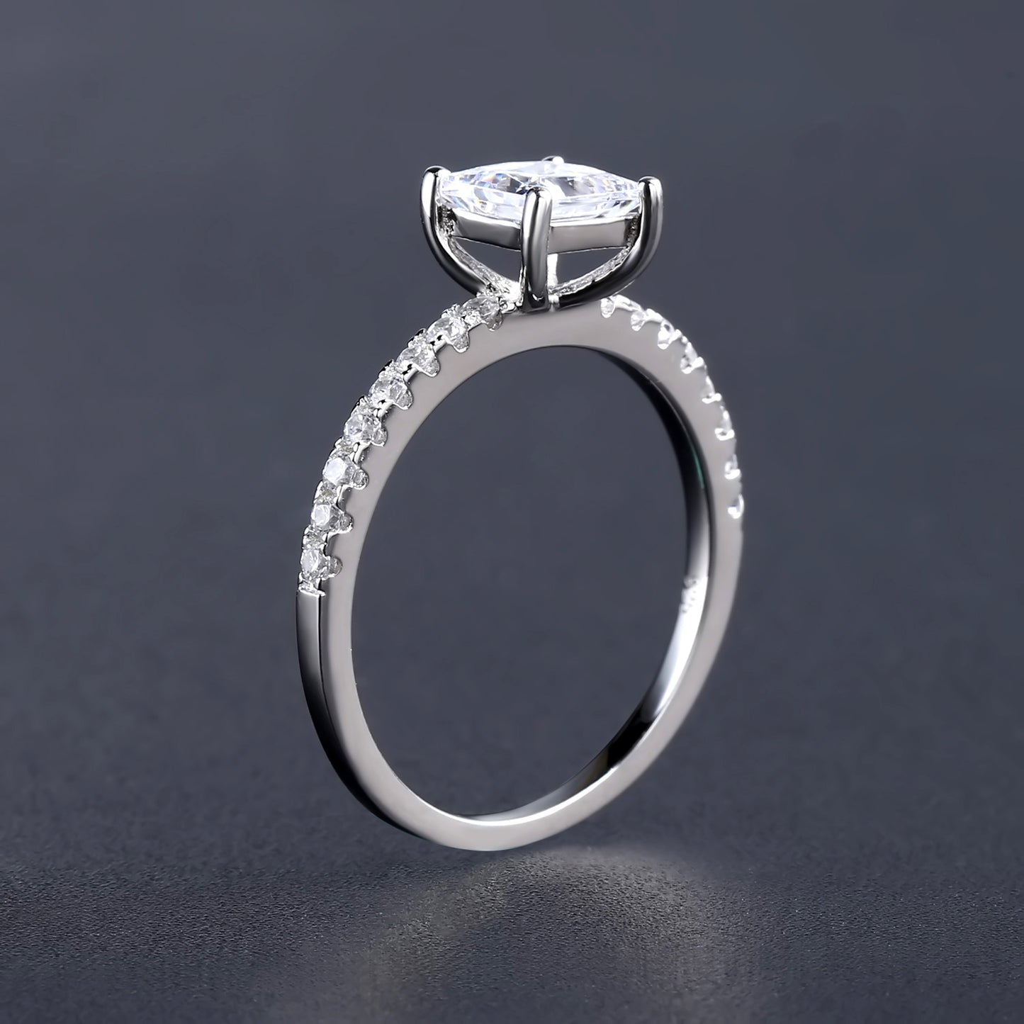 An elegant and simple sterling silver engagement ring highlighting the beauty of a 1.20ct princess cut moissanite solitaire stone.