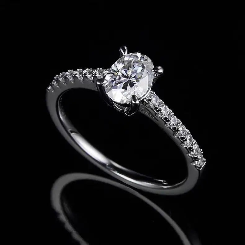 Overhead view of an oval cut moissanite engagement ring, illustrating the symmetry and simplicity of the basket setting.