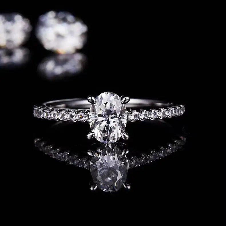 A 1.00ct oval cut moissanite engagement ring against a soft background, focusing on the stone's clarity and the ring's timeless basket setting.