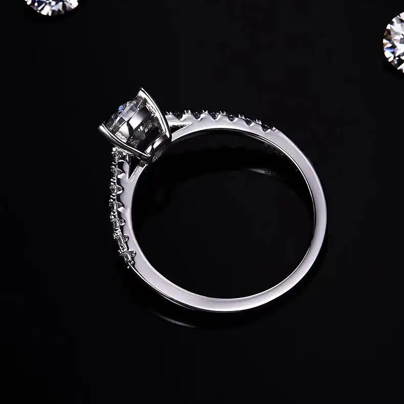 A close-up view of a 1.00ct pear-shaped moissanite in a secure basket setting, highlighting its brilliance.