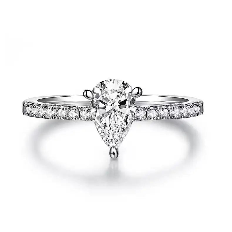 A beautiful engagement ring showcasing a brilliant 1.00ct pear-shaped moissanite held by a delicate basket setting.