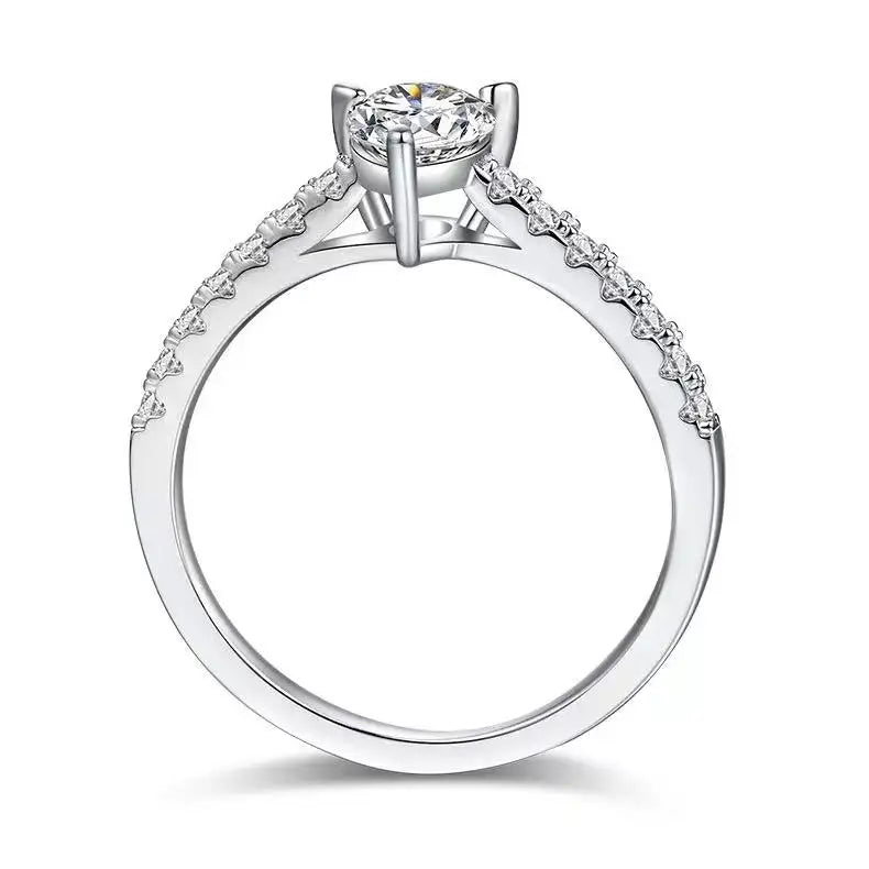 A simple and elegant solitaire engagement ring featuring a pear-shaped moissanite in a classic basket setting.