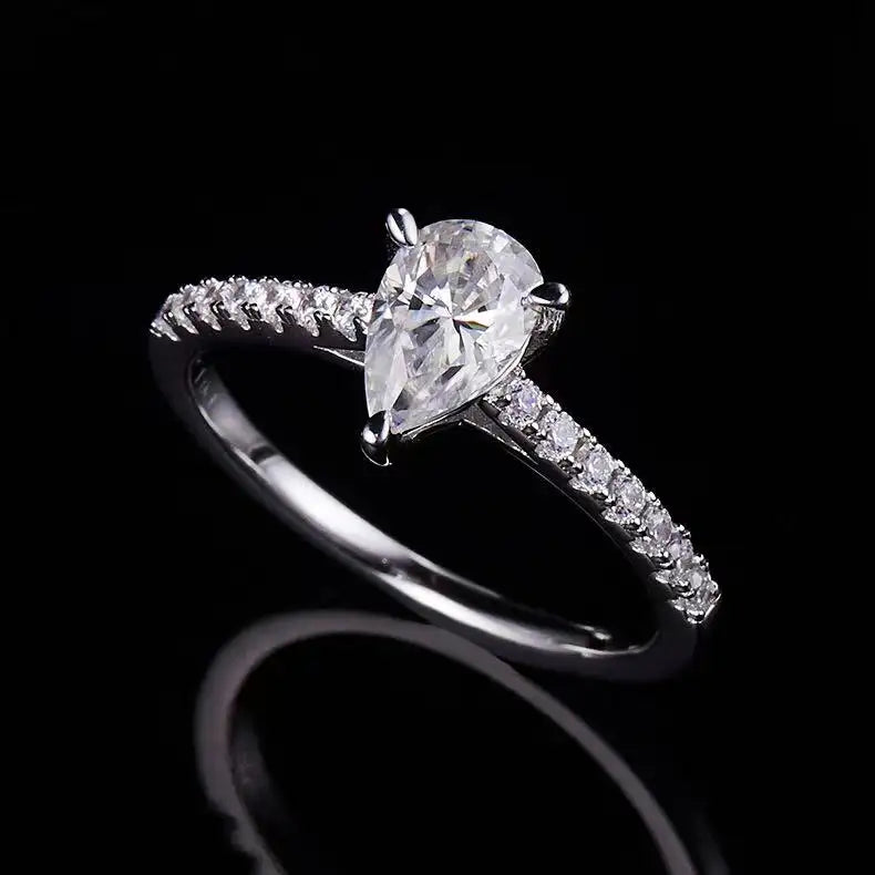A timeless engagement ring design featuring a pear-shaped moissanite set in a refined basket setting.