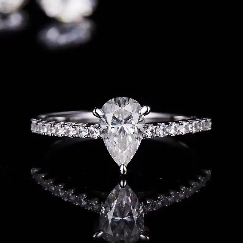 A traditional engagement ring featuring a 1.00ct pear-shaped moissanite in a secure and elegant basket setting.