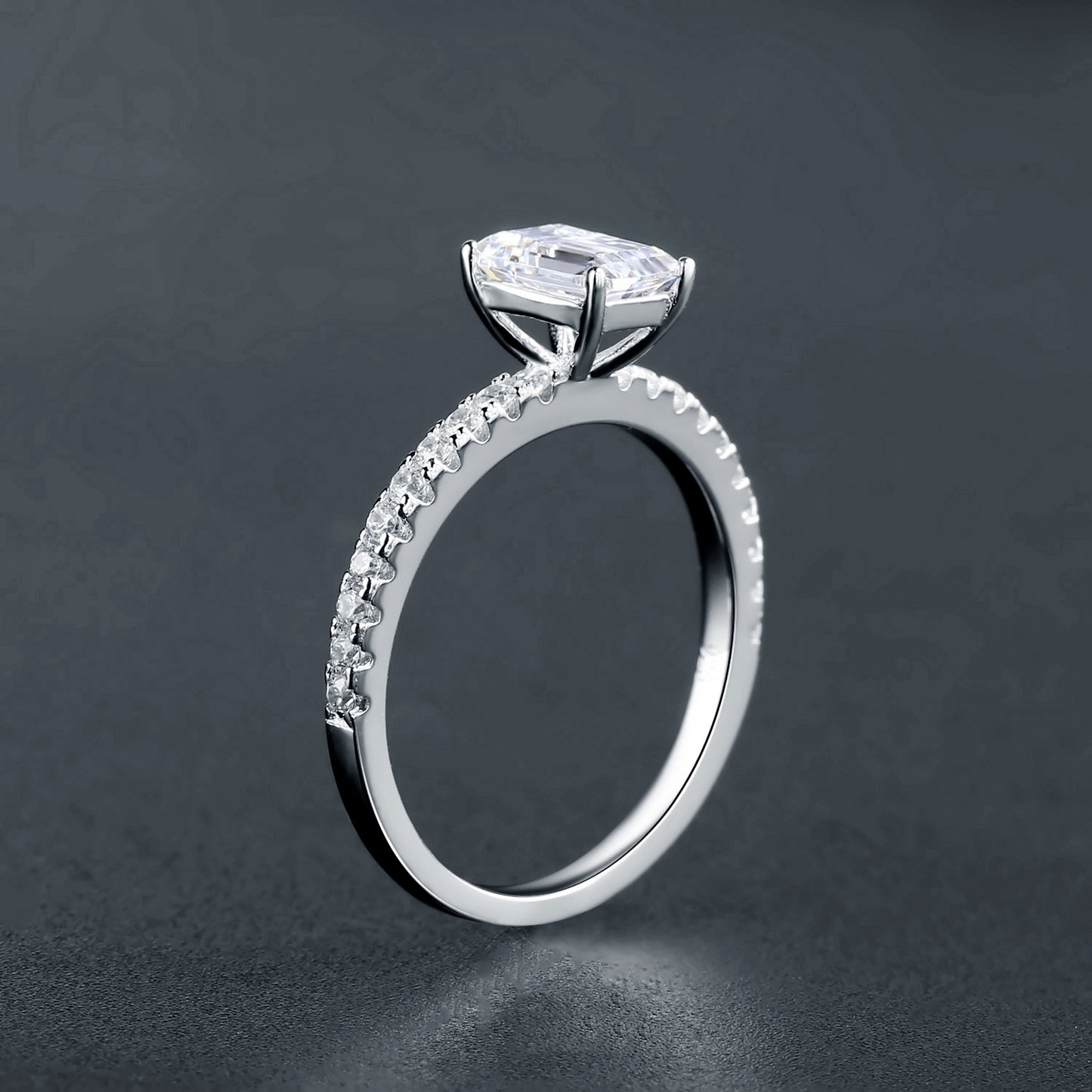 This exquisite ring features a beautifully cut 1.00ct emerald moissanite as its centerpiece, set in a sleek sterling silver band.