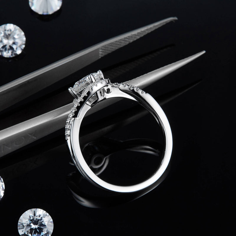 A radiant engagement ring featuring a 1.00ct moissanite with a shimmering halo, set in a classic sterling silver design.