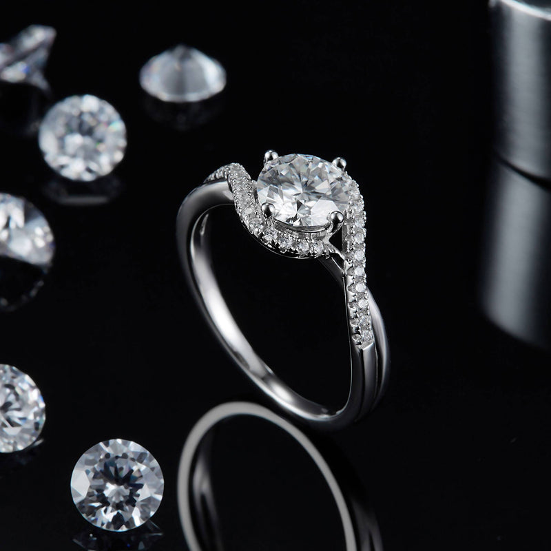 A classic and sophisticated engagement ring featuring a 1.00ct moissanite center stone with a halo of smaller stones, set in a polished sterling silver band.