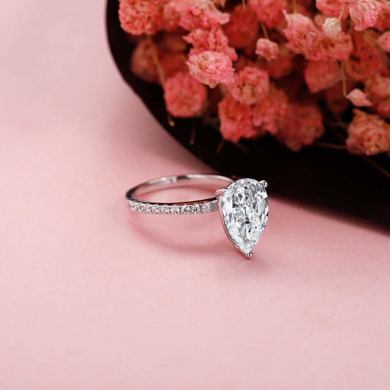 An exquisite engagement ring featuring a stunning 1.25ct pear-shaped moissanite, set in a classic sterling silver band.