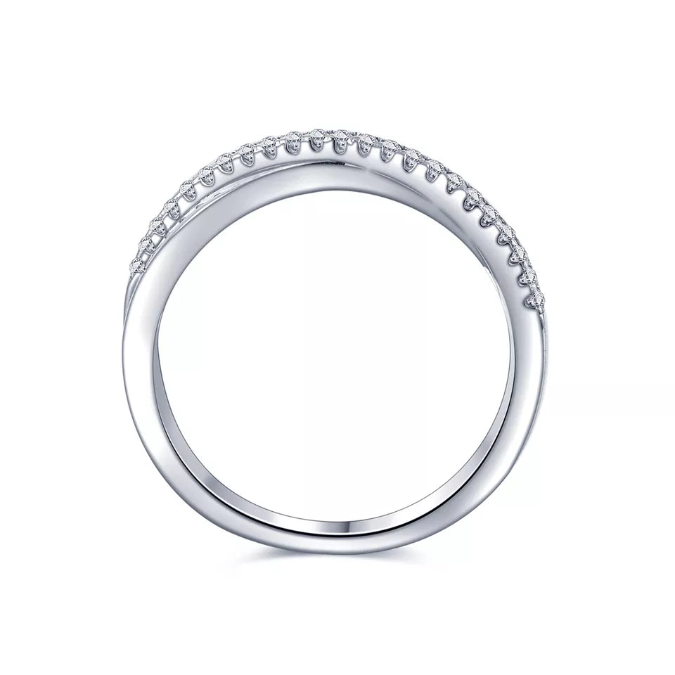 This wedding band set features a timeless infinity design, representing eternal commitment, enhanced by the sparkle of moissanites and the beauty of sterling silver.
