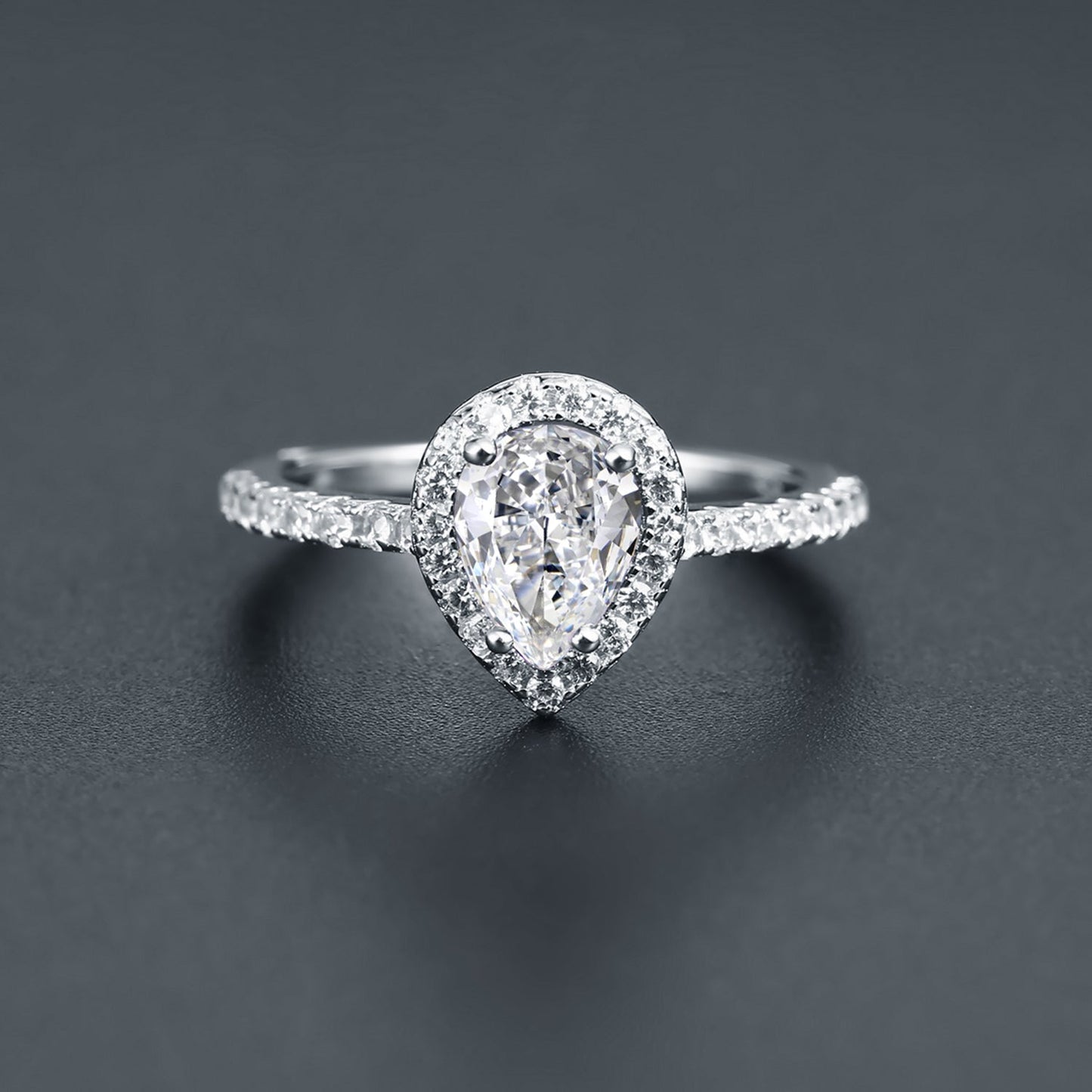 This 9ct white gold engagement ring features a beautifully cut pear-shaped moissanite surrounded by a dazzling halo.